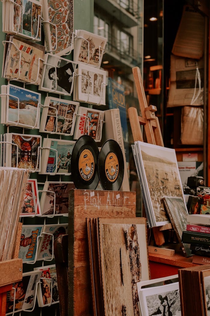gallery-1 Charming display of vinyl records, art prints, and postcards at a vintage store.