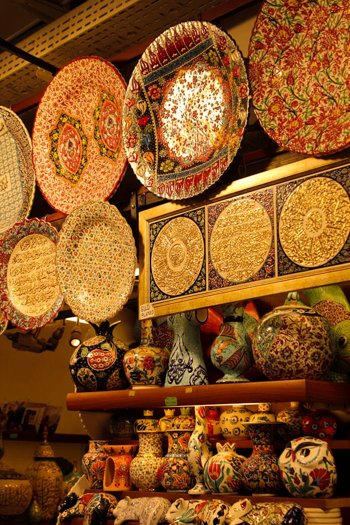 about-01 Vibrant display of handmade ceramic plates and vases with intricate patterns in a shop.